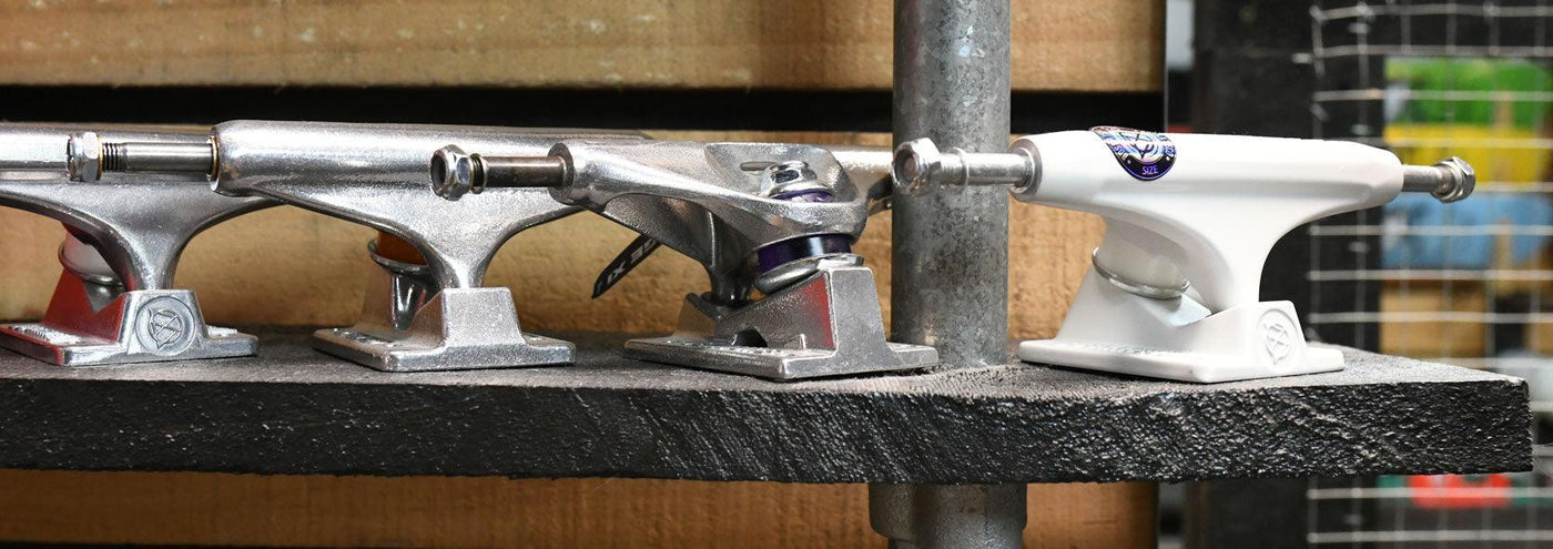 row of skateboard trucks