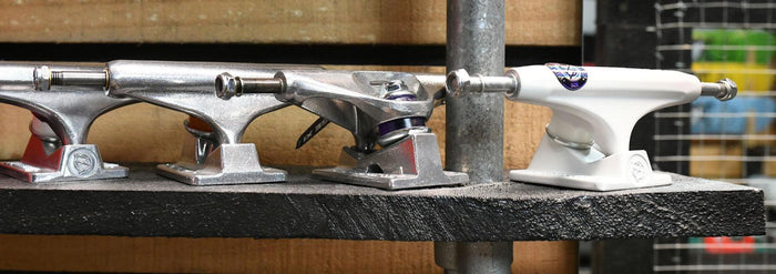 row of skateboard trucks