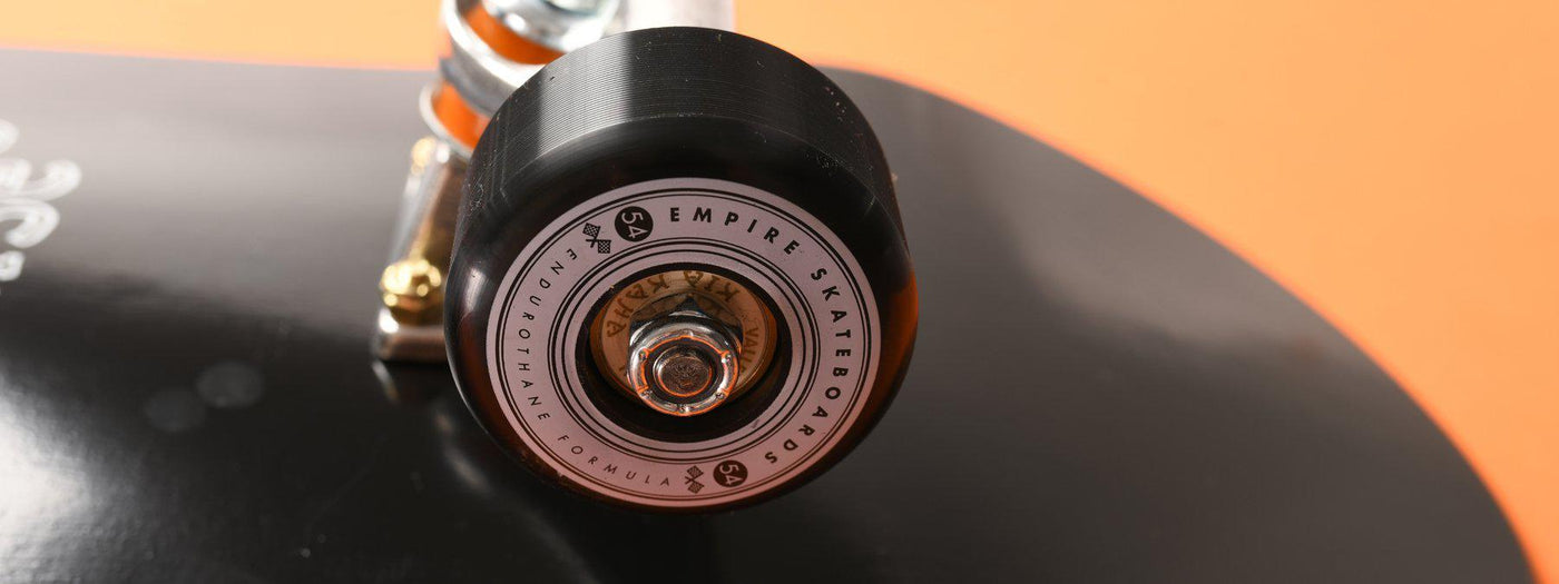 close up of empire skate wheels black orange